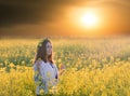 Portrait of a young woman in a rapeseed field Royalty Free Stock Photo