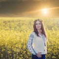 Portrait of a young woman in a rapeseed field Royalty Free Stock Photo