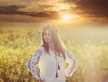 Portrait of a young woman in a rapeseed field Royalty Free Stock Photo