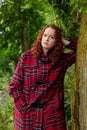 Portrait of a young woman with red hair.