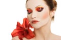 Portrait of young woman with red lily flower Royalty Free Stock Photo