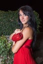 Portrait of young woman in red sleeveless dress