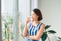 Portrait of young woman relaxing near the door and holding a cup of coffee/tea Royalty Free Stock Photo