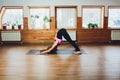 Portrait of young woman relaxing while practising yoga pose. Royalty Free Stock Photo