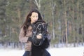 Portrait of a young woman rides on top a bay horse in winter countryside Royalty Free Stock Photo