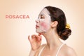 Portrait of a young woman with rosacea on her cheeks, and a fabric moisturizing mask on her face, Pink background. Side view. The