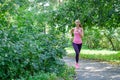 Portrait of a young woman running alone in the park Royalty Free Stock Photo