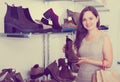 Portrait of young woman selecting loafers Royalty Free Stock Photo