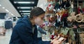 Portrait of young woman shopping in supermarket Christmas decorations