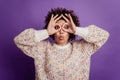 Portrait of young woman showing binoculars with fingers grimacing Royalty Free Stock Photo