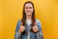 Portrait of young woman showing double thumbs up, gesturing like to camera, girl smiling broadly, expressing approval, positive Royalty Free Stock Photo