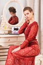 Portrait of young woman sitting at dressing table Royalty Free Stock Photo