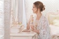 Portrait of young woman sitting at dressing table Royalty Free Stock Photo