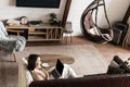 Portrait of young woman sitting at home with laptop. Asian girl using computer pc in her living room, resting on sofa Royalty Free Stock Photo