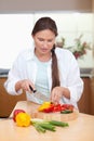 Portrait of a young woman slicing a pepper