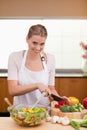 Portrait of a young woman slicing vegetables