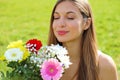 Portrait of a young woman smelling bouquet of flowers outdoor Royalty Free Stock Photo