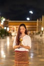 portrait young woman is smileing holding candle and praying at Wat Royalty Free Stock Photo