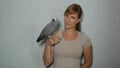 PORTRAIT: Young woman smiles as her African grey parrot sits on her finger. Royalty Free Stock Photo