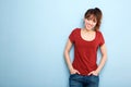 Young woman smiling against blue wall Royalty Free Stock Photo