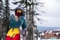 Portrait of young woman with a snowboard on a snowy slope Royalty Free Stock Photo