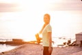 Portrait of young woman in sportswear, stopped for break between workouts. Sportswoman looks at dawn Royalty Free Stock Photo