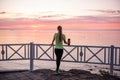 Portrait of young woman in sportswear, stopped for break between workouts. Sportswoman looks at dawn Royalty Free Stock Photo