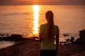 Portrait of young woman in sportswear, stopped for break between workouts. Sportswoman looks at dawn Royalty Free Stock Photo