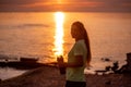 Portrait of young woman in sportswear, stopped for break between workouts. Sportswoman looks at dawn Royalty Free Stock Photo