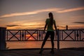 Portrait of young woman in sportswear, stopped for break between workouts. Sportswoman looks at dawn Royalty Free Stock Photo