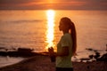 Portrait of young woman in sportswear, stopped for break between workouts. Sportswoman looks at dawn Royalty Free Stock Photo