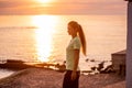 Portrait of young woman in sportswear, stopped for break between workouts. Sportswoman looks at dawn Royalty Free Stock Photo