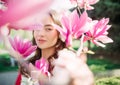 Portrait of woman in garden among blooming magnolia Royalty Free Stock Photo