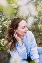 Portrait of a young woman in spring in a park