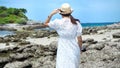 Portrait of young woman stand on the rock with sea, blue sky and cloud at Koh Sichang in Thailand. Royalty Free Stock Photo