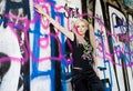 portrait of young woman standing at graffitti wall Royalty Free Stock Photo