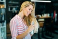 Portrait of a young woman styling her hair with spray Royalty Free Stock Photo