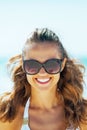 Portrait of young woman in sunglasses on beach Royalty Free Stock Photo