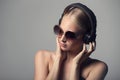 portrait of young woman in sunglasses and headphones. Royalty Free Stock Photo