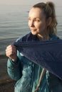 portrait of a young woman at sunset on the shore of the Gulf of Finland in early spring