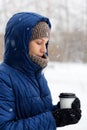 Portrait of a young woman surrounded by flying snowflakes Royalty Free Stock Photo