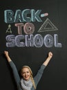 Portrait of a young woman, teacher in front of a blackboard