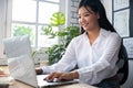 Portrait of young woman teacher with laptop at desk in classroom Royalty Free Stock Photo