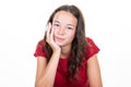 Portrait of young woman teenager hand on chin over white wall background