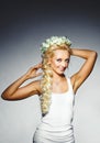 Portrait of young woman with thick blond hair and natural clean skin. Beautiful girl with wreath on head.