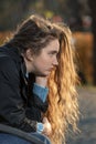 Portrait of Young woman with thick kinky hair.brooding cute girl with beautiful long auburn hair outdoor