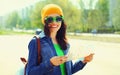 Portrait of young woman tourist sightseeing big city with paper map Royalty Free Stock Photo