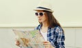 Young woman tourist sightseeing city with paper map Royalty Free Stock Photo