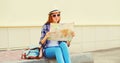 Portrait of young woman tourist sightseeing city with paper map Royalty Free Stock Photo