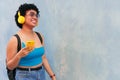 Portrait of a young woman from an urban background listening to music with headphones Royalty Free Stock Photo